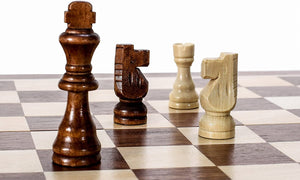 closeup of a chess board with 4 random chess pieces setup