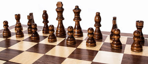close-up of a chess board with dark brown chess pieces setup