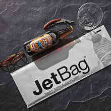 Load image into Gallery viewer, lifestyle image showing a jet bag, a bottle of beer, and glasses
